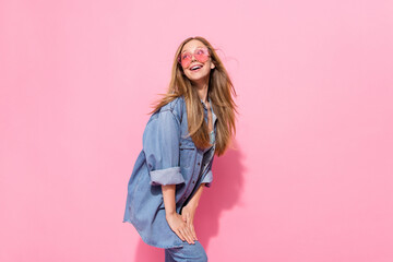 Photo portrait of pretty young teen girl posing defile shopping promo dressed stylish denim outfit isolated on pink color background