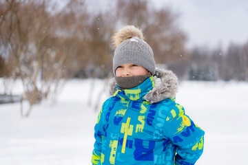 winter portrait of cute caucasian boy on sunny day