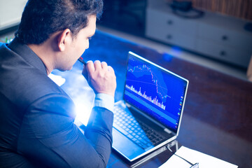 Stock market trader working on laptop,  Financial market trading, Candlestick chart graphic , Bitcoin Crypto, forex. Stress, economy, data,  business. Technology, strategy, depression. 
