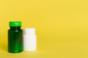 Plastic bottles for vitamins on color background