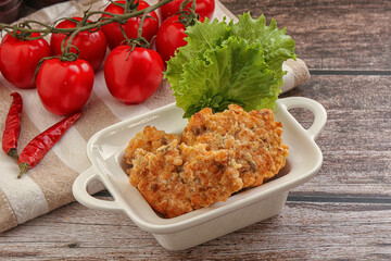 Fried salmonn cutlet in the bowl