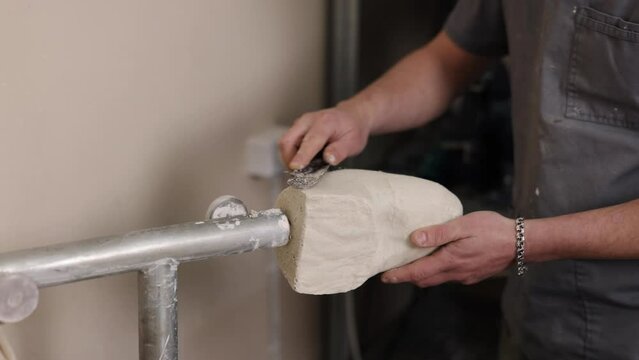 Mold development, Prosthetic innovation, Leg prosthesis. Innovator crafting mold for hip disarticulation prosthetic leg by removing nonessential components.