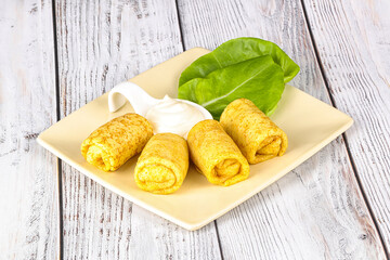 Stuffed pancakes with cream sauce
