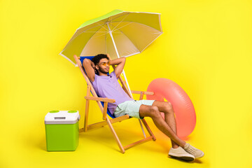 Full length cadre of funny guy wear sunglass sunbed under parasol near beer fridge will swim rubber...