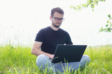 Work with a computer outdoors. Modern technology. Work with computer technologies