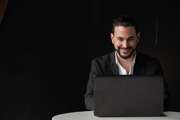 Portrait of handsome businessman using laptop computer while smiling - 611011975