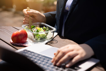 A female office worker is having a lunch break alone at work.