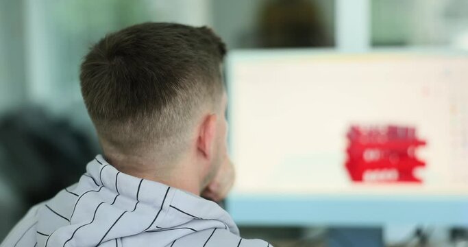 Engineer working on desktop computer, software and 3d modeling are displayed on screen. Background engineering office with industrial design drawings on computer