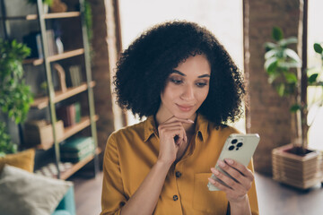 Photo of charming minded corporate girl arm finger touch chin use smart phone chatting communicate loft interior indoors
