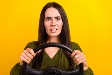 Fototapeta na wymiar Portrait of impressed speechless girl arms hold wheel staring isolated on yellow color background