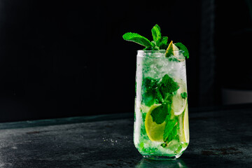 summer alcoholic cocktail mojito with ice, fresh mint and lime