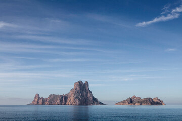 The island of es vedra in sunny day, beautiful reflection of blue sky, Ibiza, Spain - 611024985