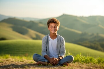 Naklejka na ściany i meble Environmental portrait photography of a grinning boy in his 30s practicing yoga against a rolling hills background. With generative AI technology