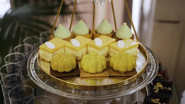 Candy bar. Sweets on stands. Delicious desserts at the banquet. Mousse desserts, sponge cakes, shortbread tarts, chocolate and cocoa desserts. Confectionery at the celebration. Sweets with sugar.