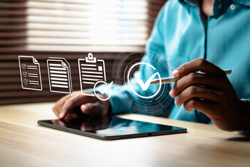 Businessman checkmarking for approval document, online paperless approval and quality assurance concept.