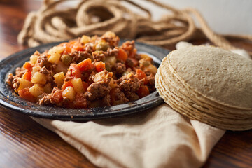 Picadillo, stew popular in Mexico and Latin America made with meat, carrots, potatoes and olives.