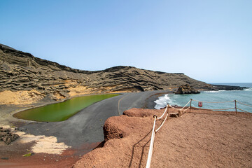 a landscape image overlooking the green lake on the beach of El Golfe in Lanzarote. - obrazy, fototapety, plakaty