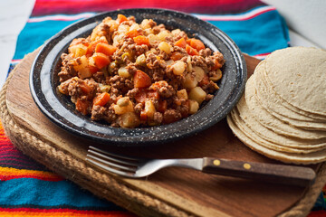 Picadillo, stew popular in Mexico and Latin America made with meat, carrots, potatoes and olives.