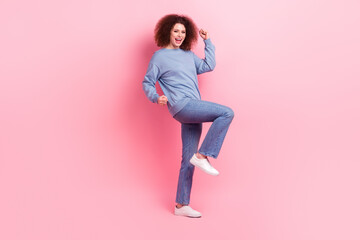 Full body cadre of overjoyed excited girl wear blue shirt denim jeans raised fists up enjoy shopping isolated on pink color background