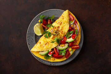 omelette with tomato, avocado onion chili and sweet corn. healthy keto diet low carb breakfast