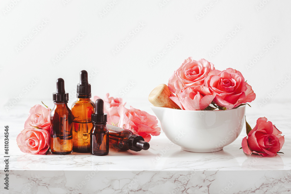 Wall mural essential oils in bottles rose flowers. alternative medicine spa aromatherapy