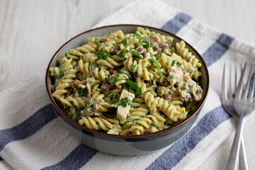 Homemade Chicken Spinach Alfredo Rotini Pasta in a Bowl, side view.