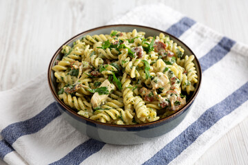 Homemade Chicken Spinach Alfredo Rotini Pasta in a Bowl, low angle view. Close-up.
