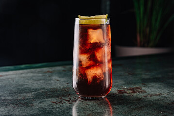 Fresh made coktail Cuba Libre with brown rum, cola and lemon 