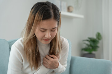 hand hold chest with heart attack symptoms, asian woman have chest pain caused by heart disease,...