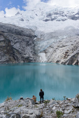 Hiker couple overlooking glacier lake in Mountain landscape, Andes, Peru