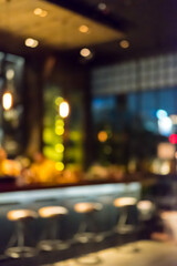 Fototapeta na wymiar Blurred image bokeh of Seating inside the restaurant, bar counter