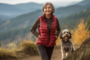Medium shot portrait photography of a satisfied mature woman walking a dog against a scenic mountain overlook background. With generative AI technology
