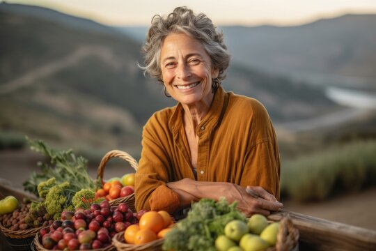 Medium shot portrait photography of a happy mature woman harvesting fruits or vegetables against a scenic mountain overlook background. With generative AI technology