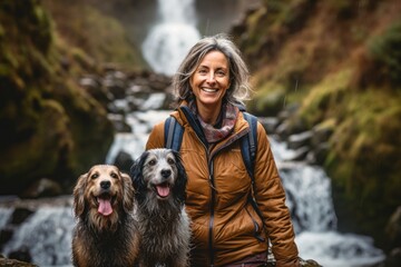 Medium shot portrait photography of a grinning mature woman walking with a dog against a picturesque waterfall background. With generative AI technology