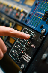 Fototapeta na wymiar Sound Engineer Using Digital Audio Mixer Sliders Engineer Pressing Power Button Control Panel Recording Studio Technician Close-up