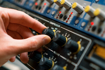 Sound engineer using digital audio mixer sliders Engineer pressing keys adds control panel volume...