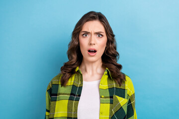 Fototapeta premium Photo of shocked crazy offended woman with curly hairdo dressed checkered shirt staring open mouth isolated on blue color background