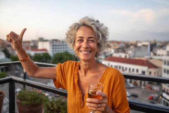 Medium shot portrait photography of a grinning mature woman showing ok gesture against a lively rooftop bar background. With generative AI technology