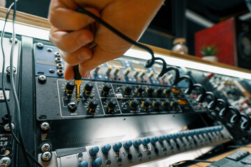 sound engineer connects Audio cable Professional wires with connectors to music equipment recording...