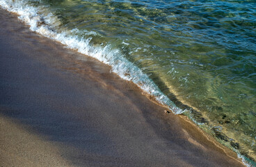 Waves on a Tan Sand Beach in Hawaii.