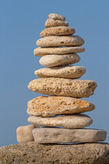Fototapeta na wymiar tower made of stones against blue sky