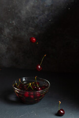Fresh sweet cherries in a glass bowl close up. Space for text - 611049585