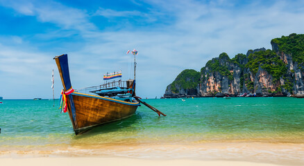 beautiful scenery of a boat on an island in thailand by day