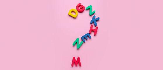 Question mark made of colorful letters on pink background