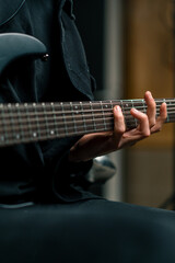 Fototapeta premium rock performer with electric guitar in recording studio recording playing own track creating song musical instrument strings close-up