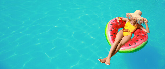 Beautiful young woman relaxing on inflatable ring in swimming pool. Banner for design
