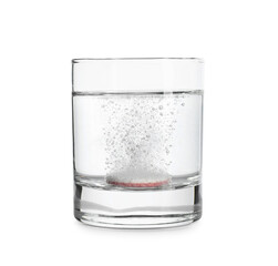 Glass of water with soluble tablet isolated on white background