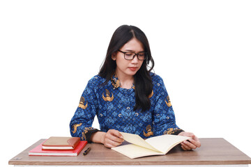 Serious Asian female in batik korpri, indonesian traditional worker uniform reading a book