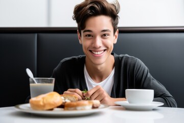 Obraz na płótnie Canvas Close-up portrait photography of a grinning boy in his 30s having breakfast against a white background. With generative AI technology