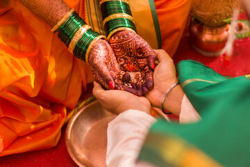 Indian groom and bride holding hands for hindu wedding ceremony